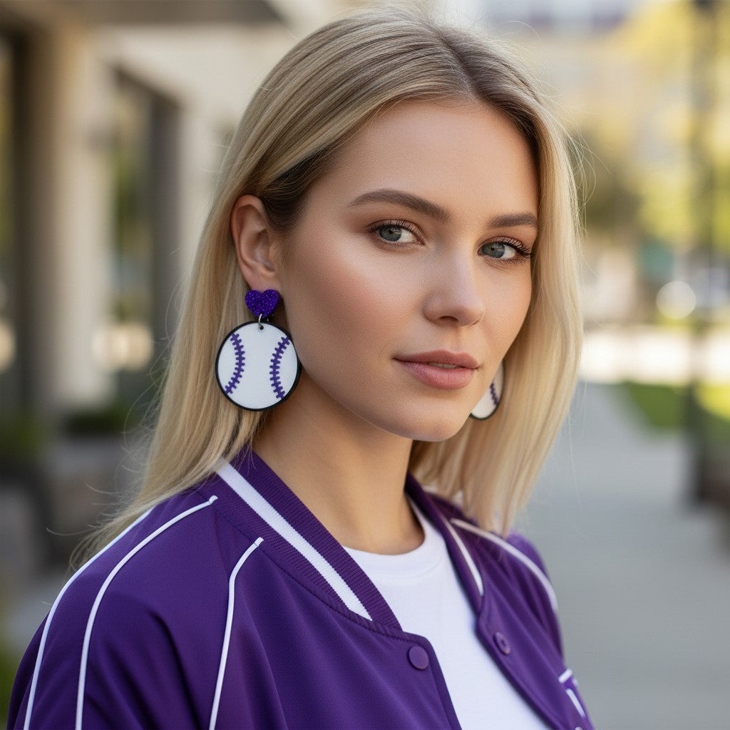 Trulyolive purple glitter heart baseball dangle earrings with white and purple stitching.